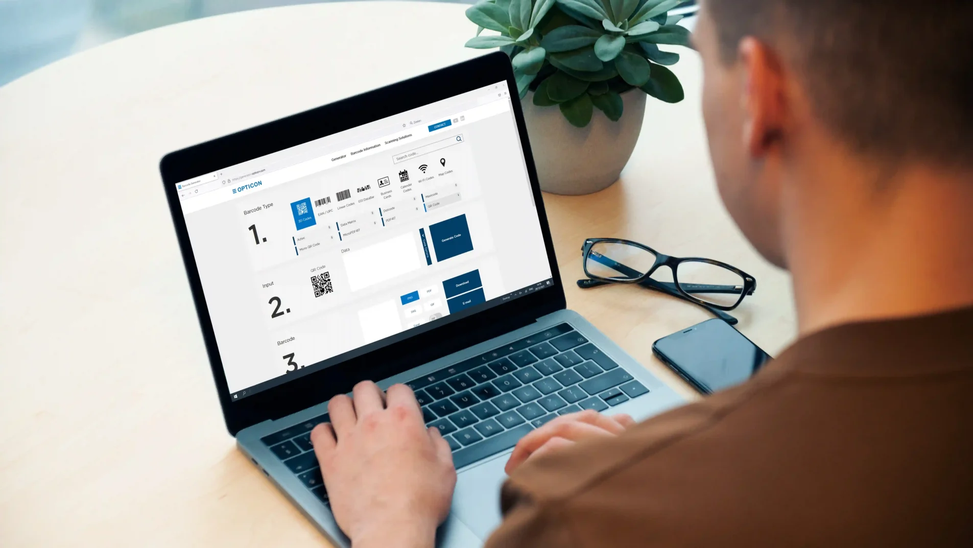 Man with laptop using the Opticon barcodegenerator