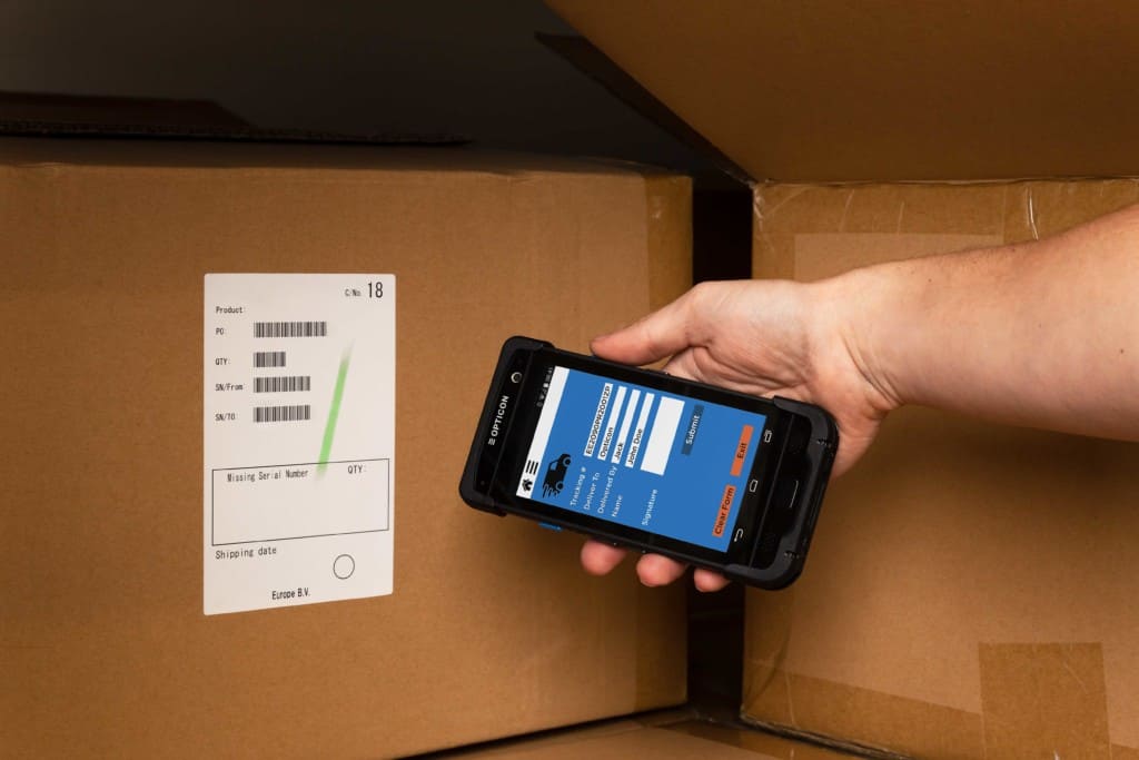 H-28 Android Mobile Computer used to scan barcodes on a box in a warehouse